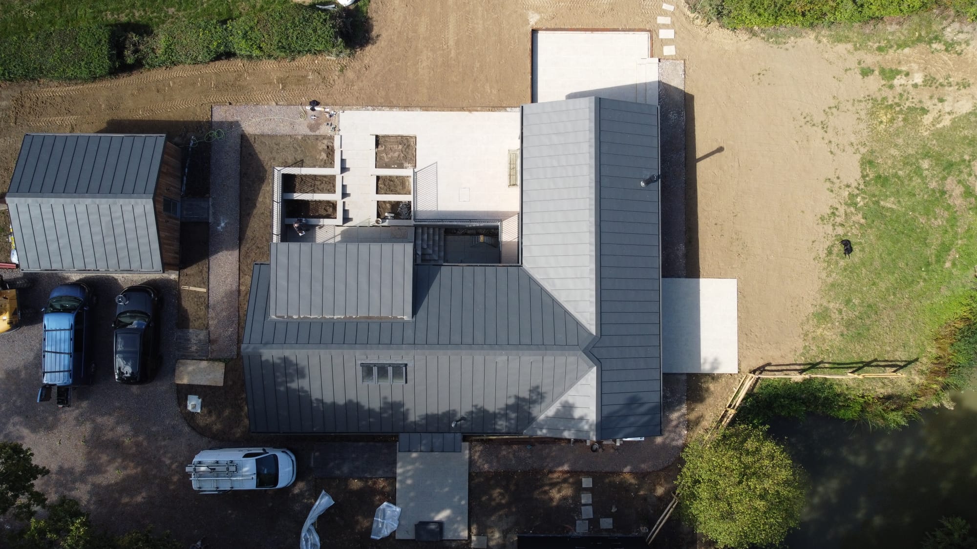 Drone view of a large site with new paving around a house