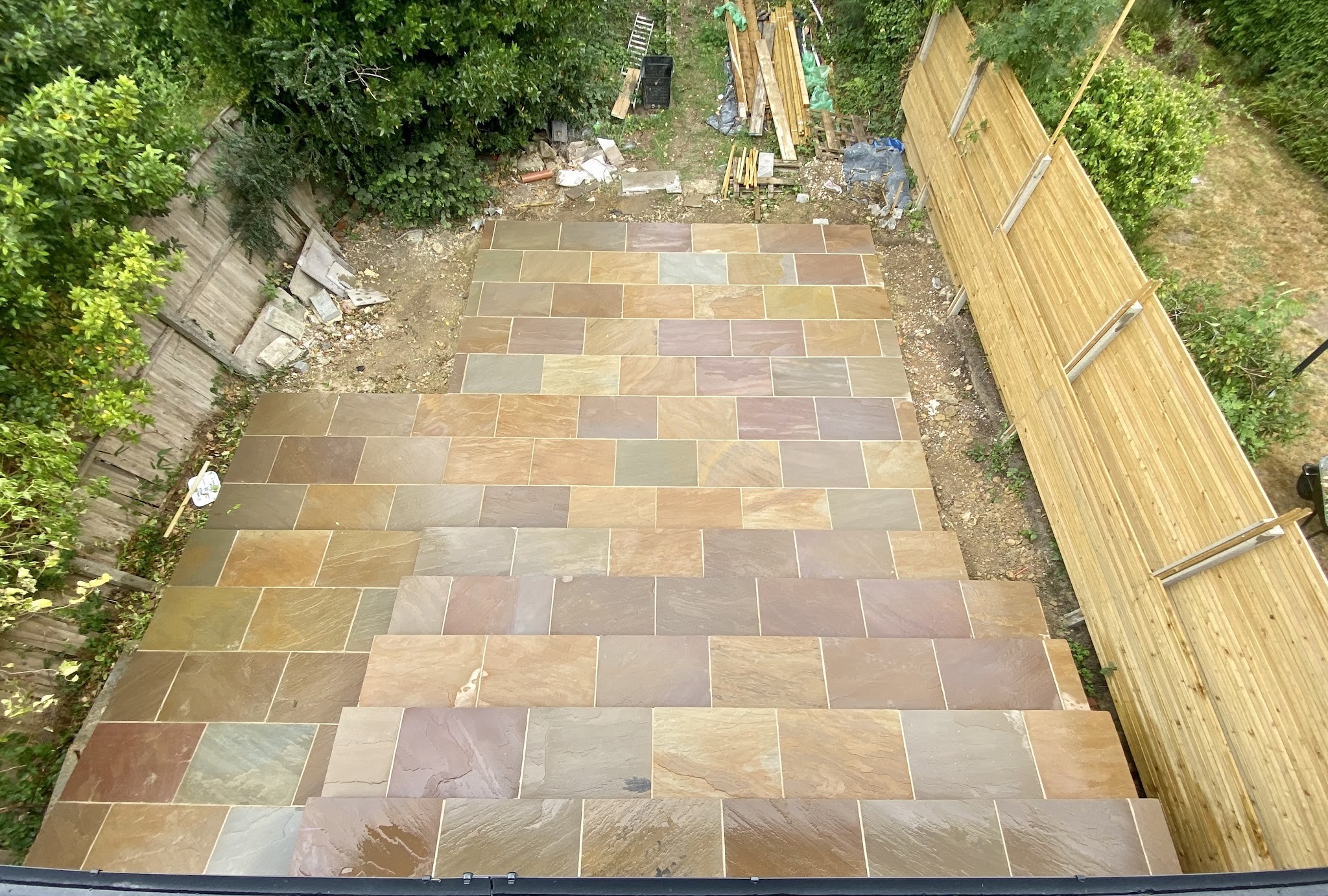Patio laid the full width of a narrow garden, seen from above