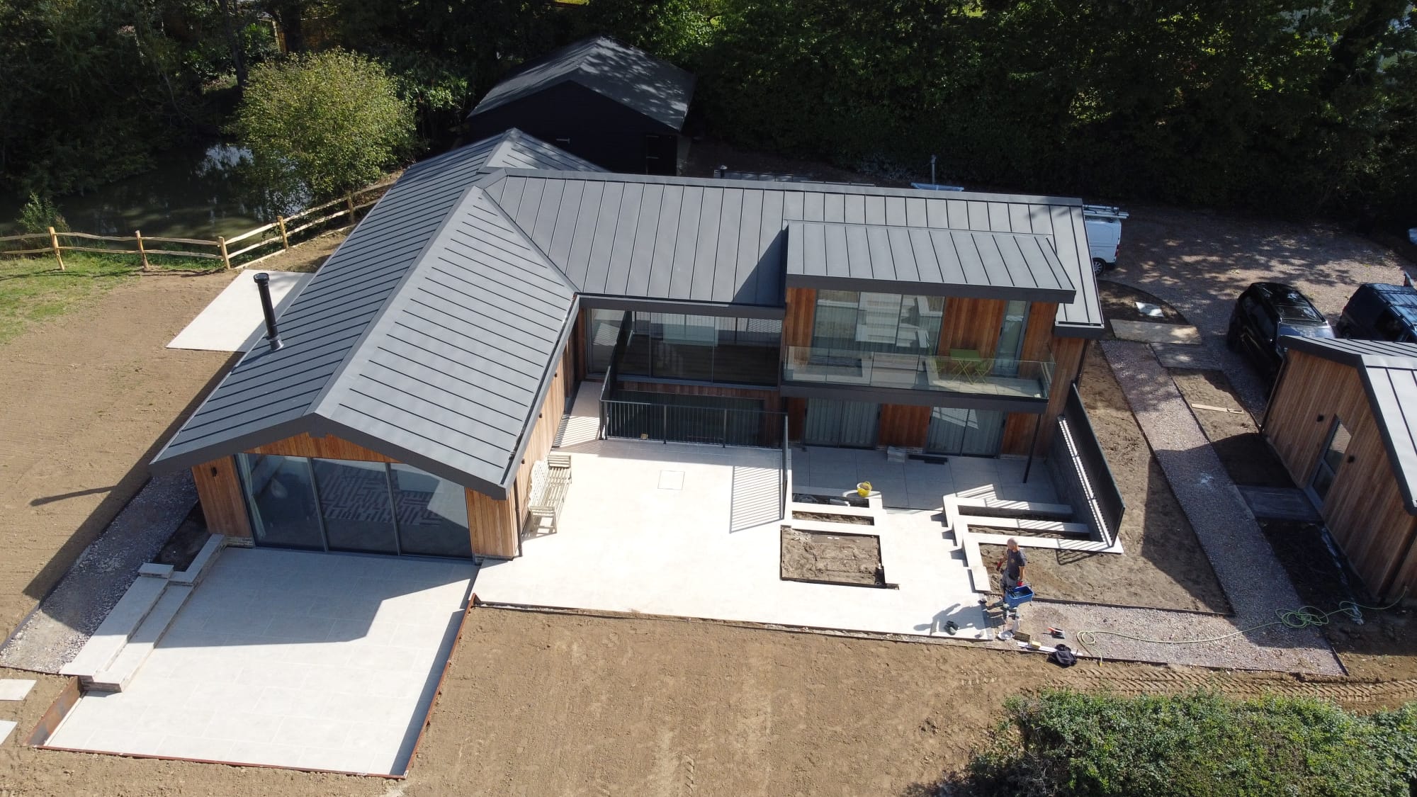 Drone view of a new terrace around a modern timber-clad house
