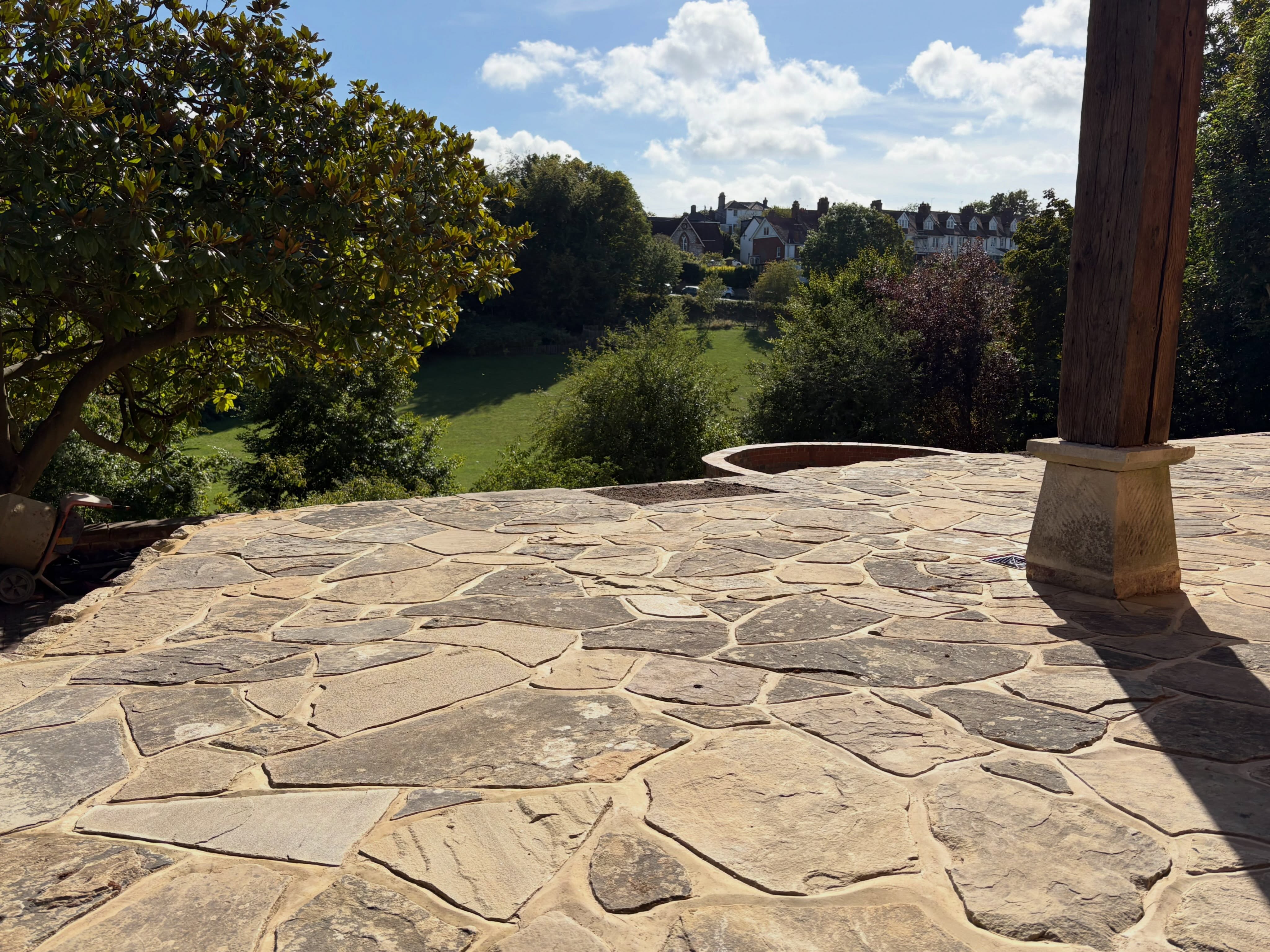 Stone terrace looking out over trees and countryside